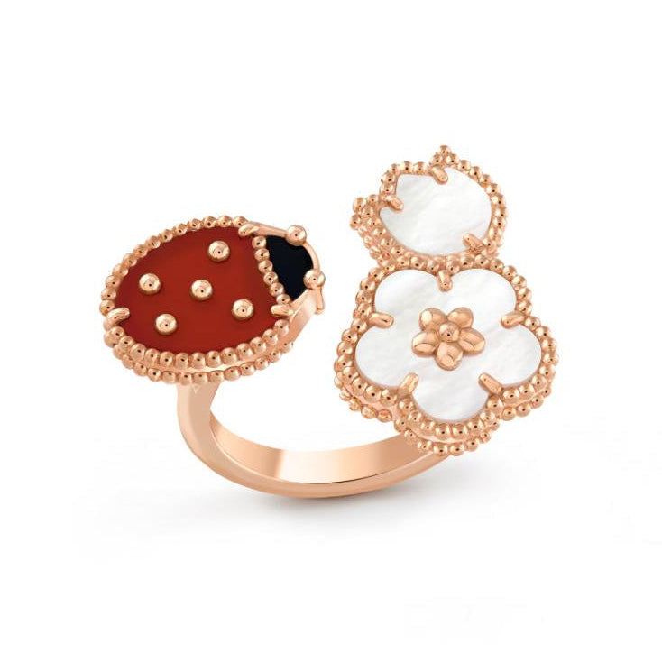 ring with a ladybug and flower design on a white background