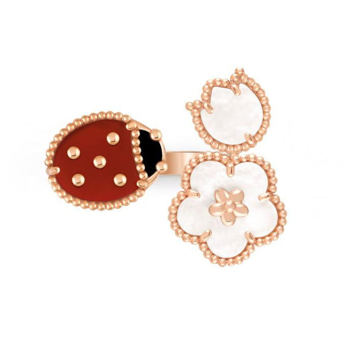Gold ring with ladybug and flower design on a white background