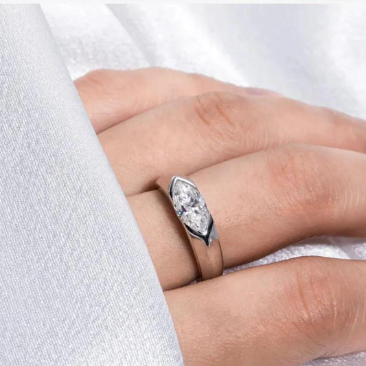 A marquise-cut moissanite ring with a 1ct D-color VVS1 clarity, set in sterling silver and plated in 18K white gold.