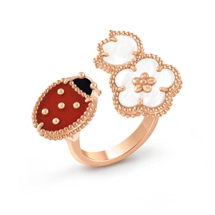 Rose gold ring with a ladybug charm on a white background