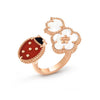 Rose gold ring with a ladybug charm on a white background