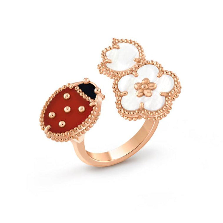 Rose gold ring with a ladybug charm on a white background